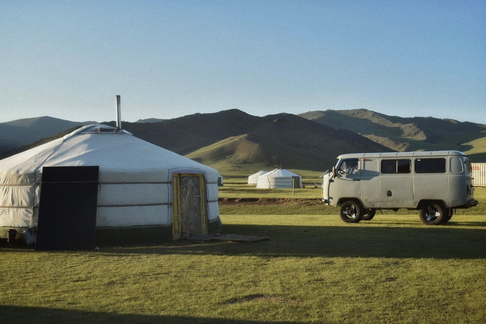 Ger and van camp beneath the mountains