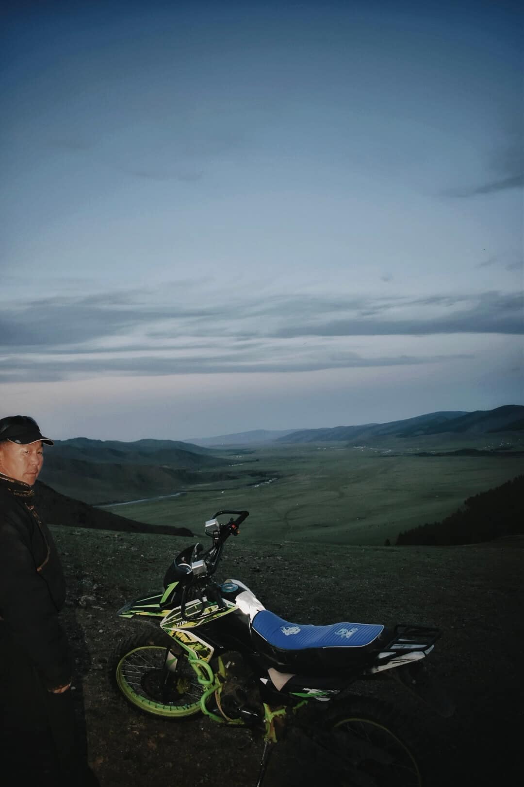 Motorbike above the valley at dusk
