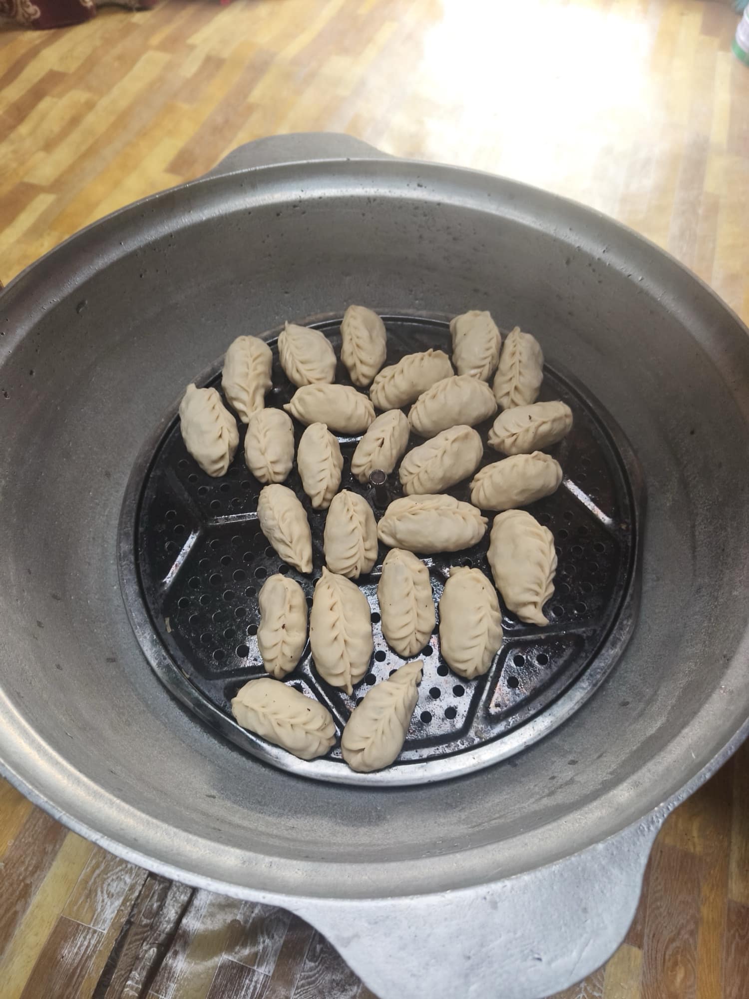 Hand-folded buuz dumplings in the steamer
