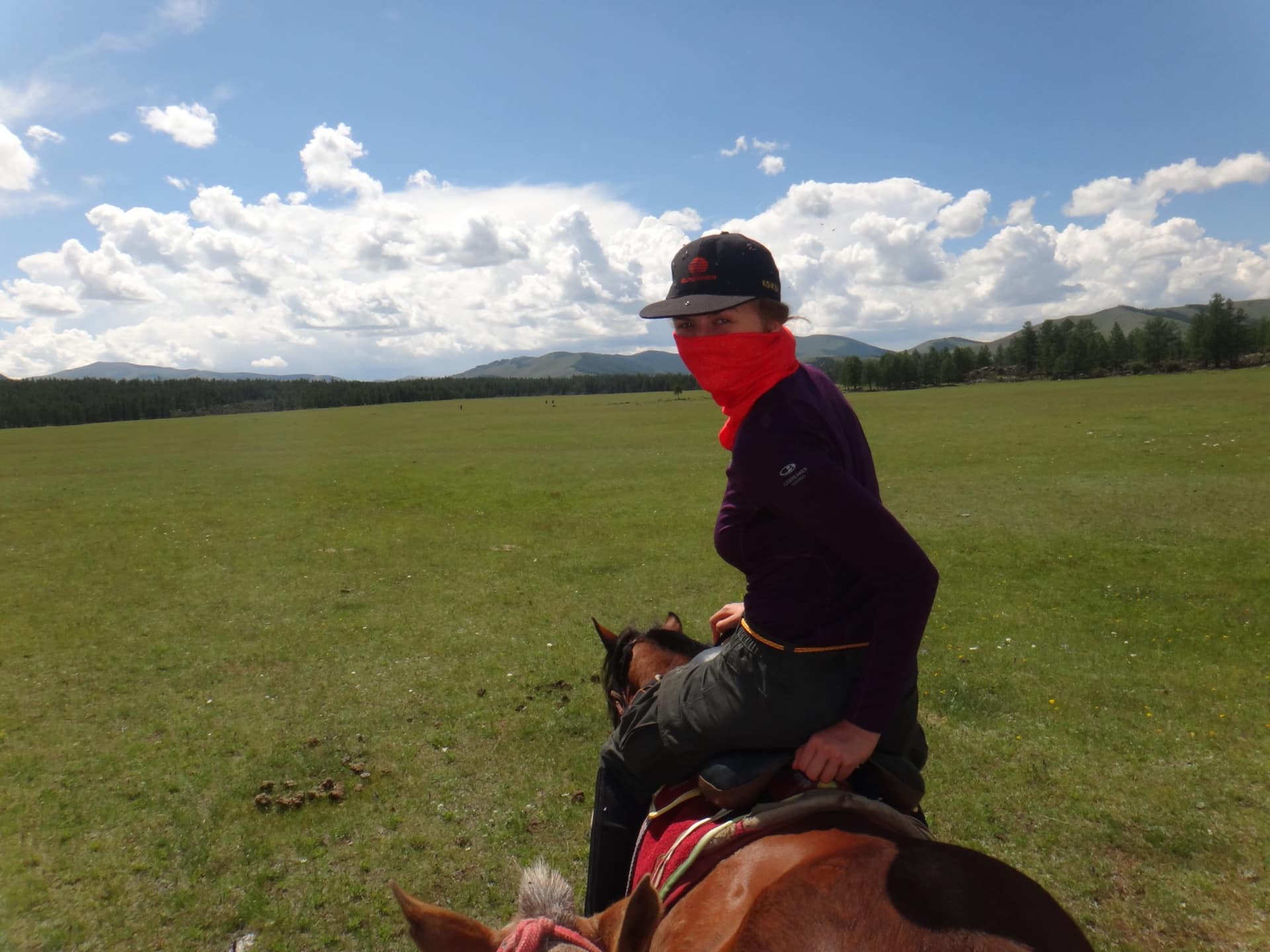 A guest on horseback crossing the open plain
