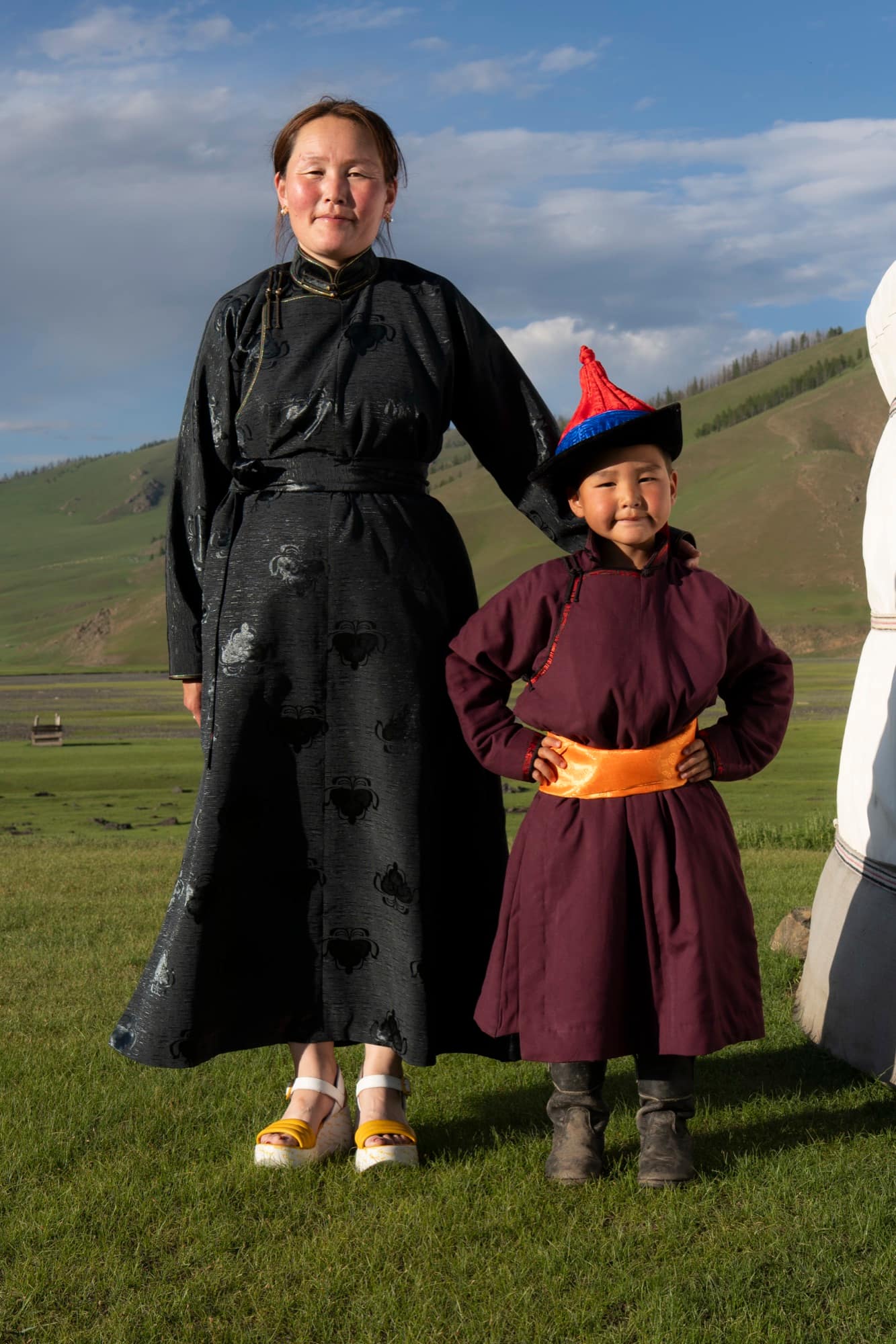 Mother and small child in traditional deels beside the ger