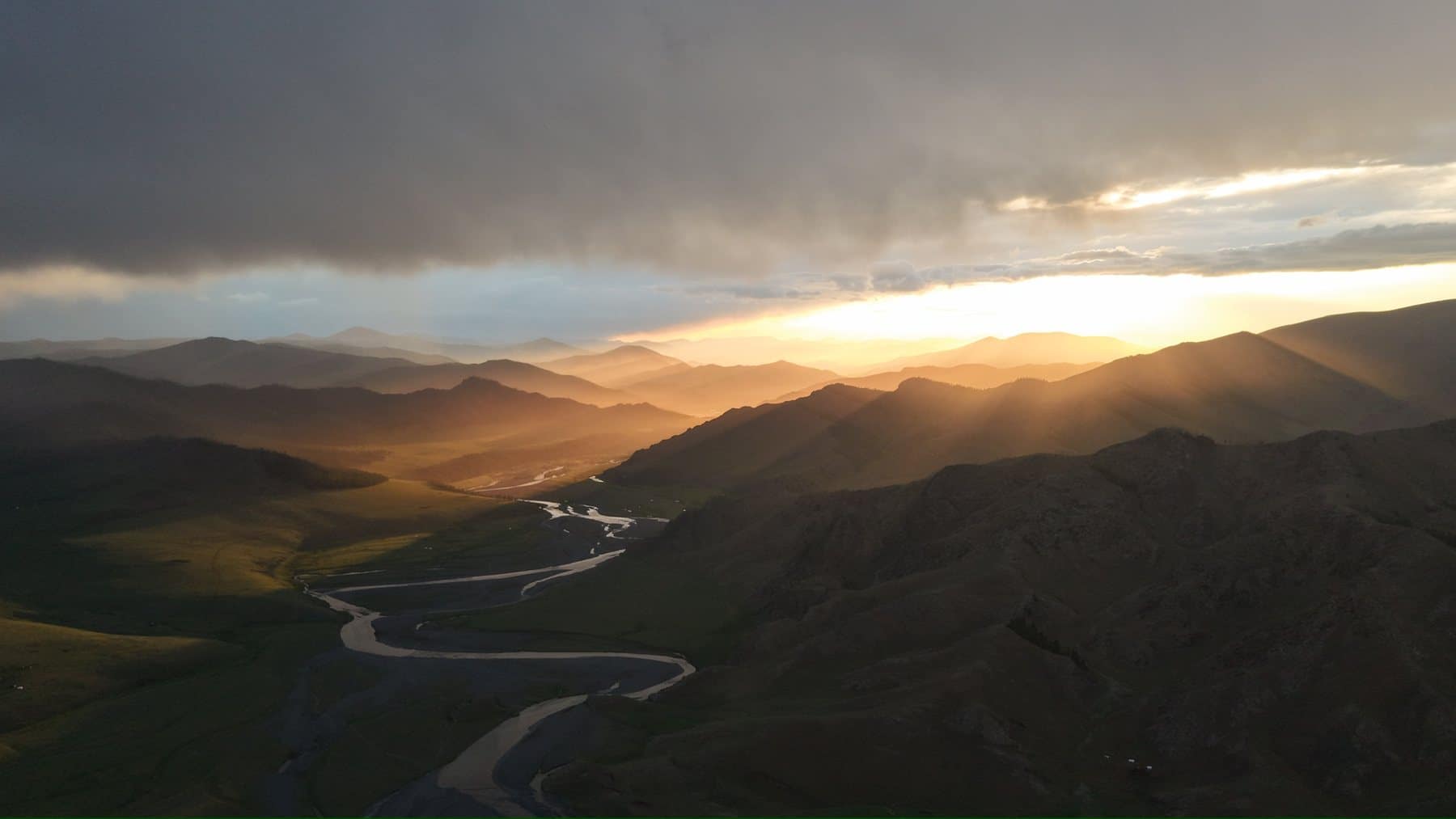 Sunburst over the Orkhon Valley river bends after rain
