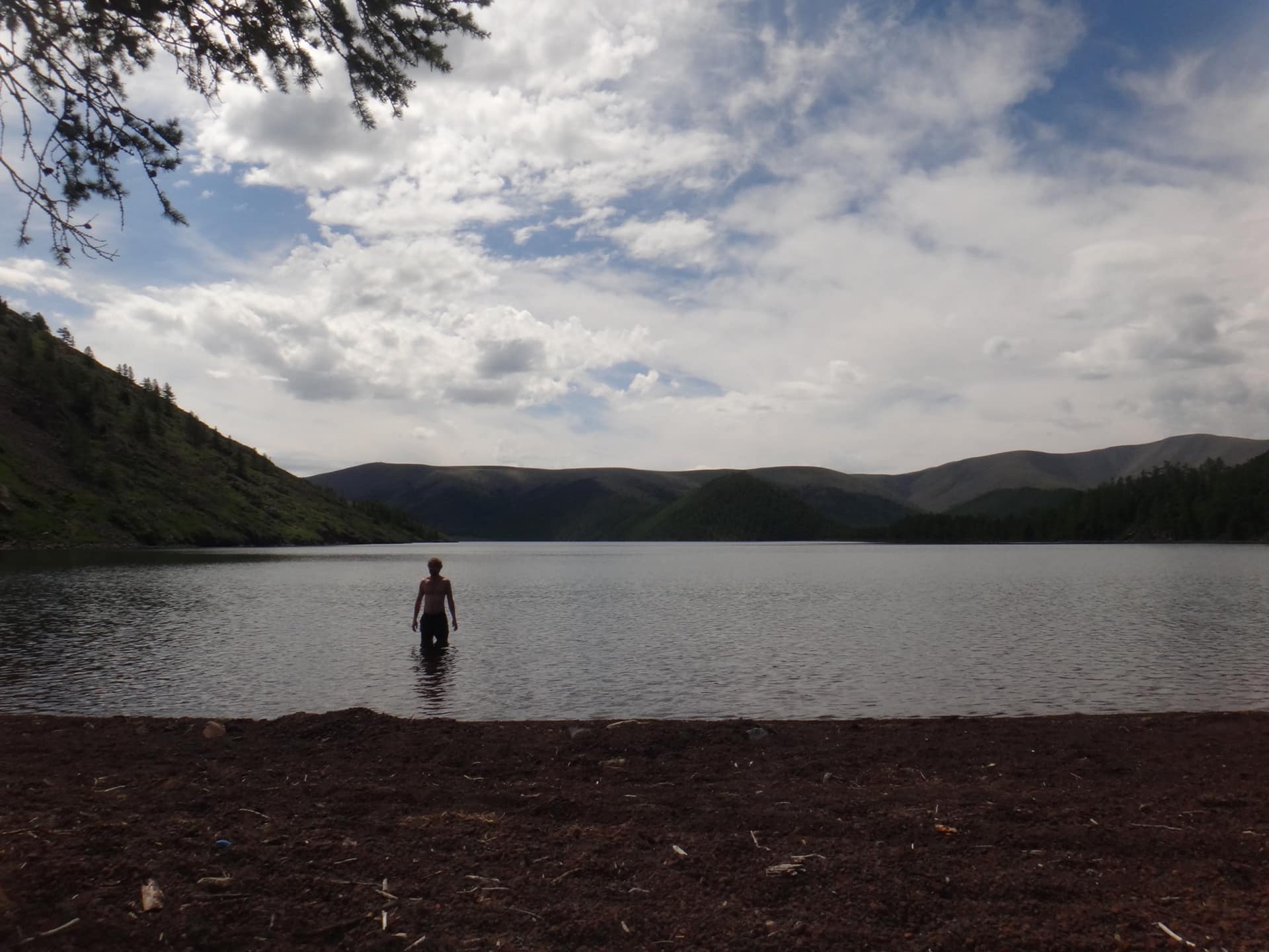 A guest wading into one of the Eight Lakes
