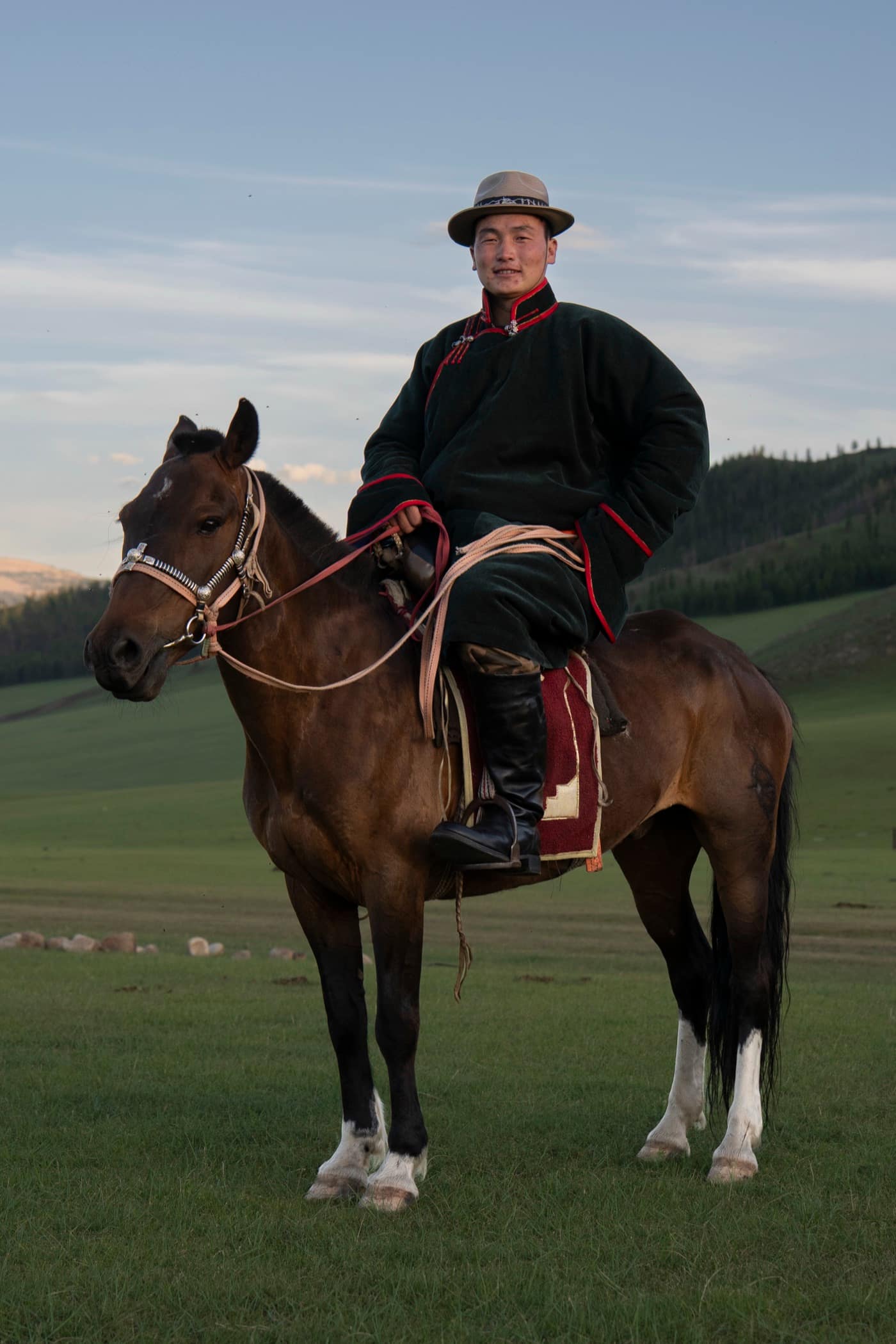 Suma on horseback in a traditional deel on the Mongolian steppe