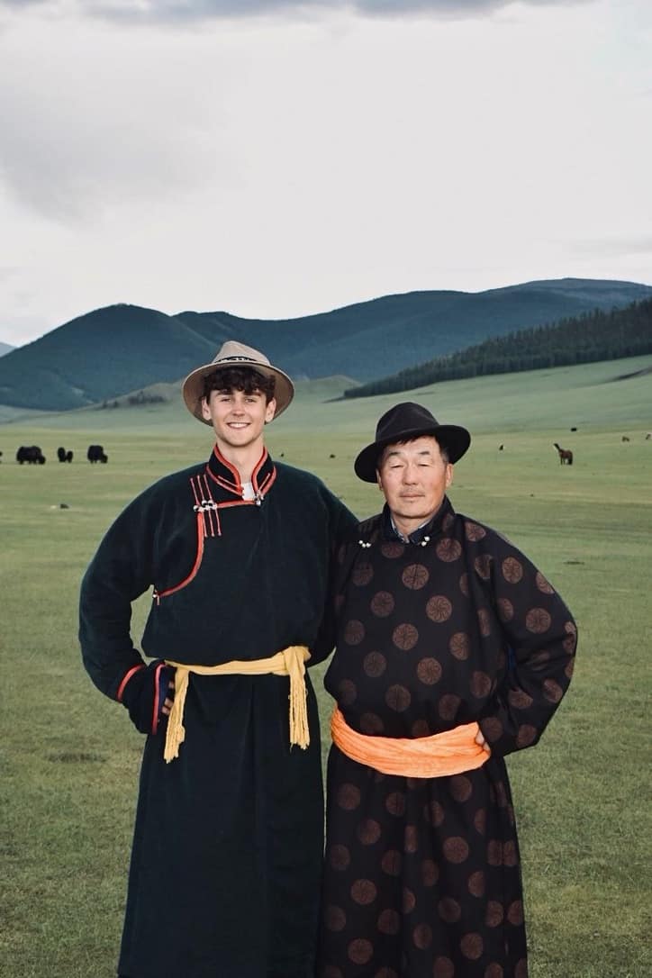Fin and his Mongolian host in traditional deels on the steppe