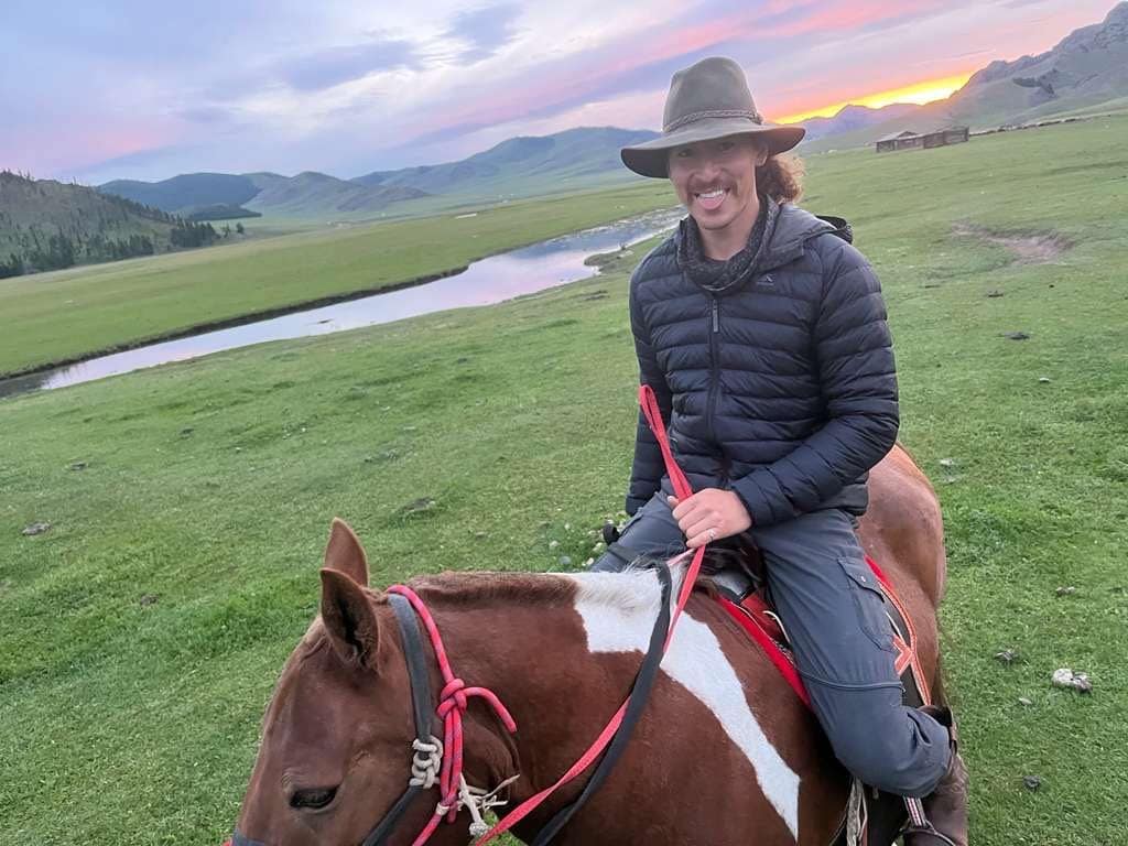 Irik riding at sunset