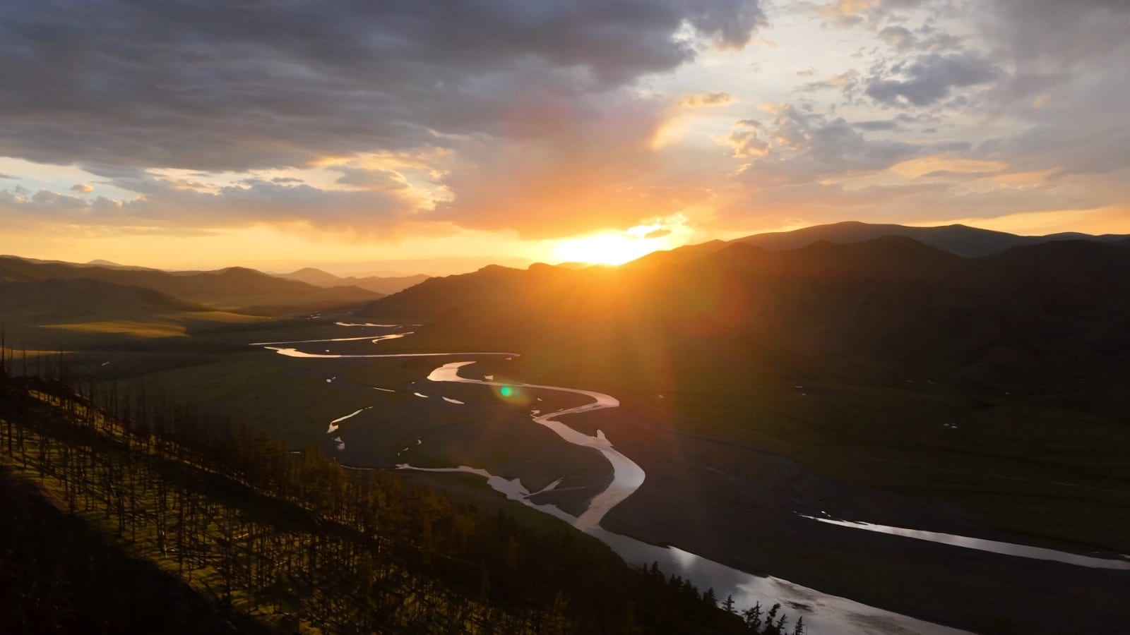 Drone view of a golden sunset over the Orkhon Valley and its winding river in Mongolia